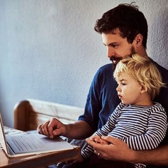 Man on laptop with son