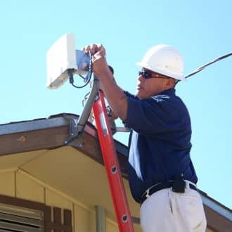 Sacred Wind employee installs fixed wireless home internet