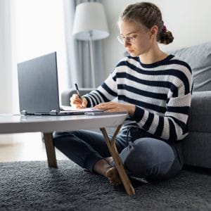 Teenage girl attending online class from home