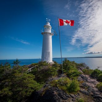canadian flag and lighthouse