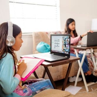 Girls at home attending school.