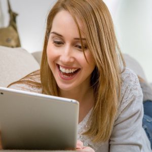 Woman on tablet at home. Windstream RDOF