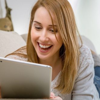 Woman on tablet at home. Windstream RDOF