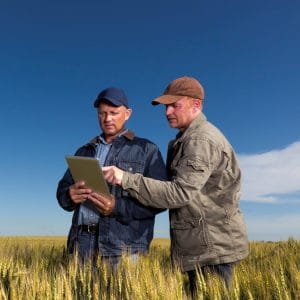 Farmers in rural area on laptop