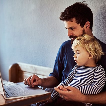 Man on laptop with son