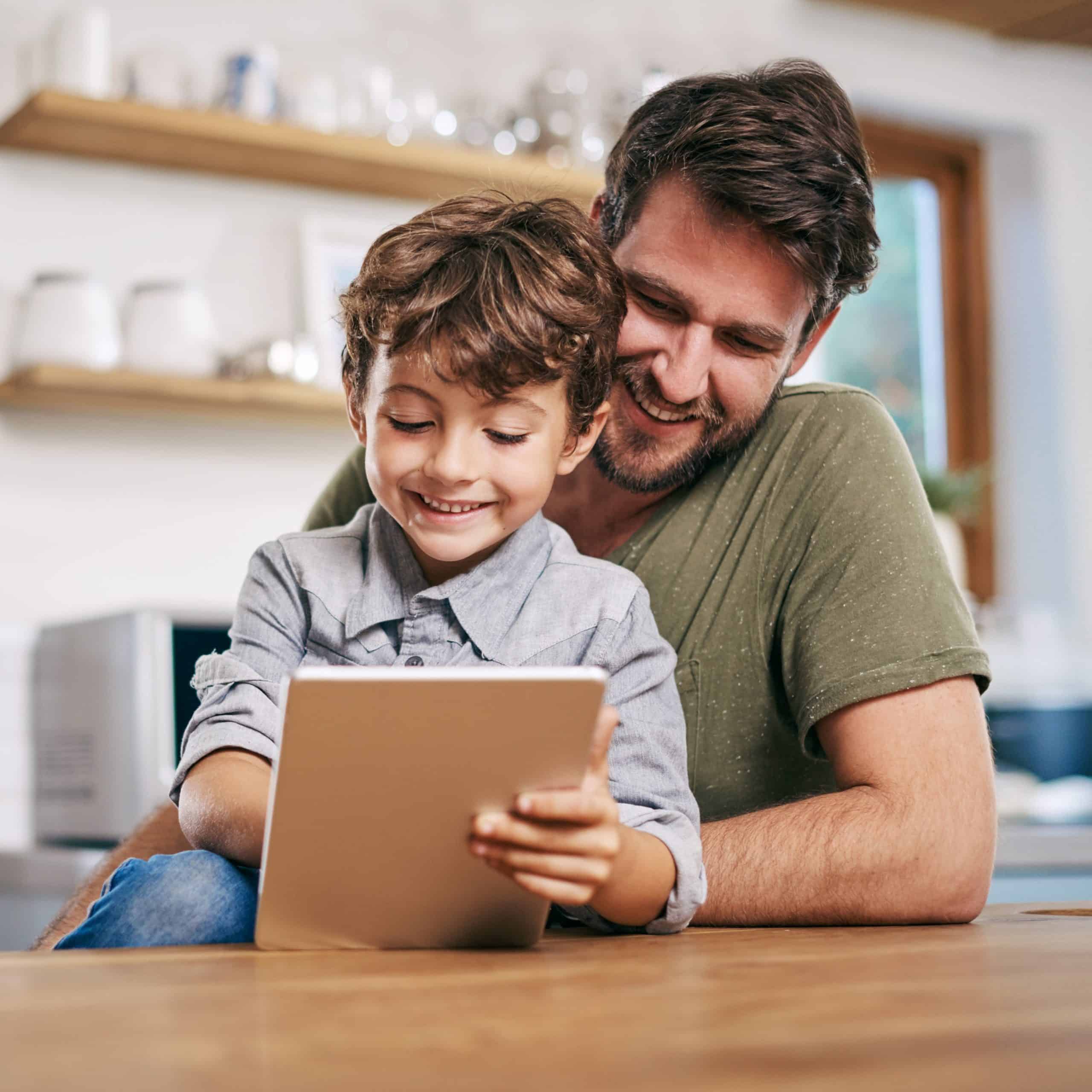Single dad with son on tablet