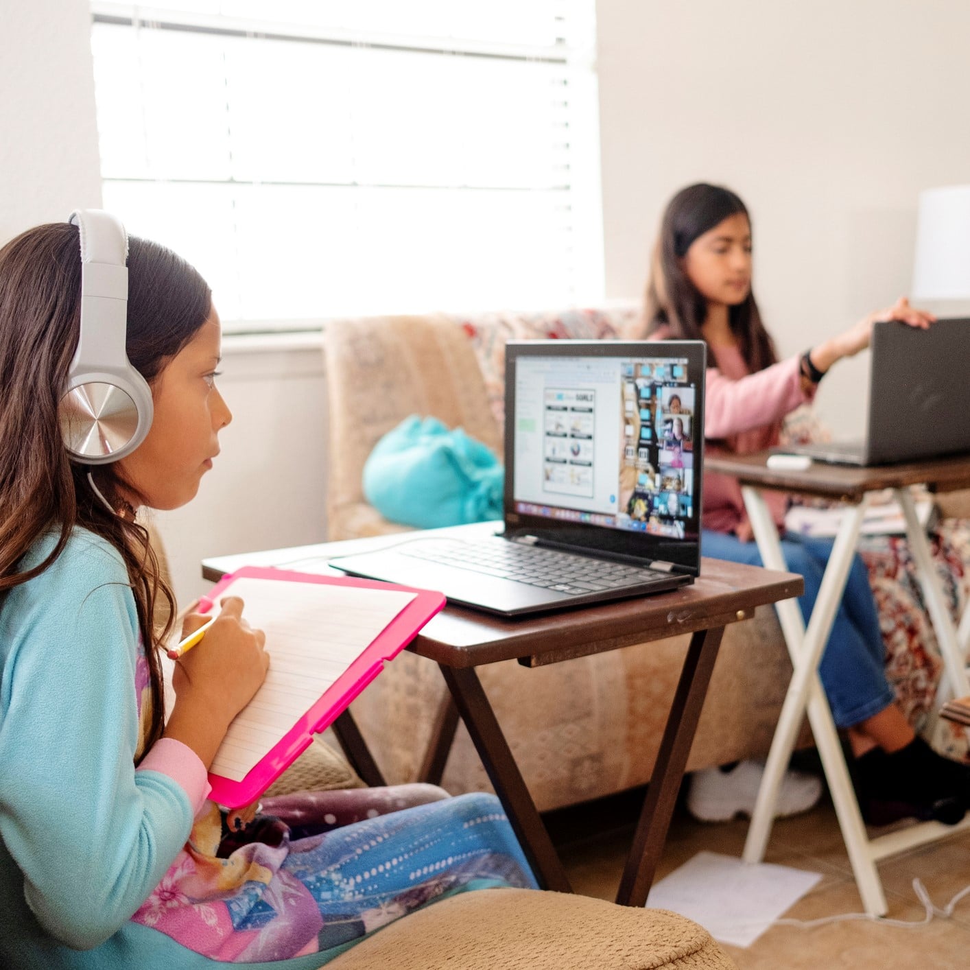 Girls at home attending school.