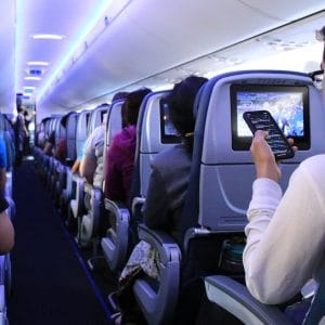 passenger on airplane on phone