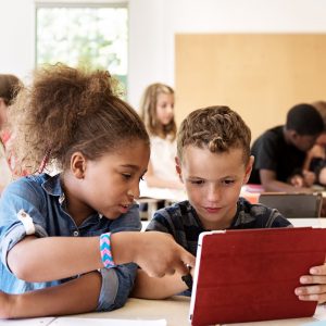 School kids in class using a digital tablet