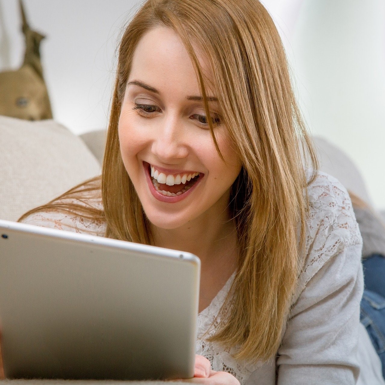 Woman on tablet at home. Windstream RDOF